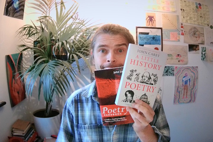 hoto of me holding two books in my study.