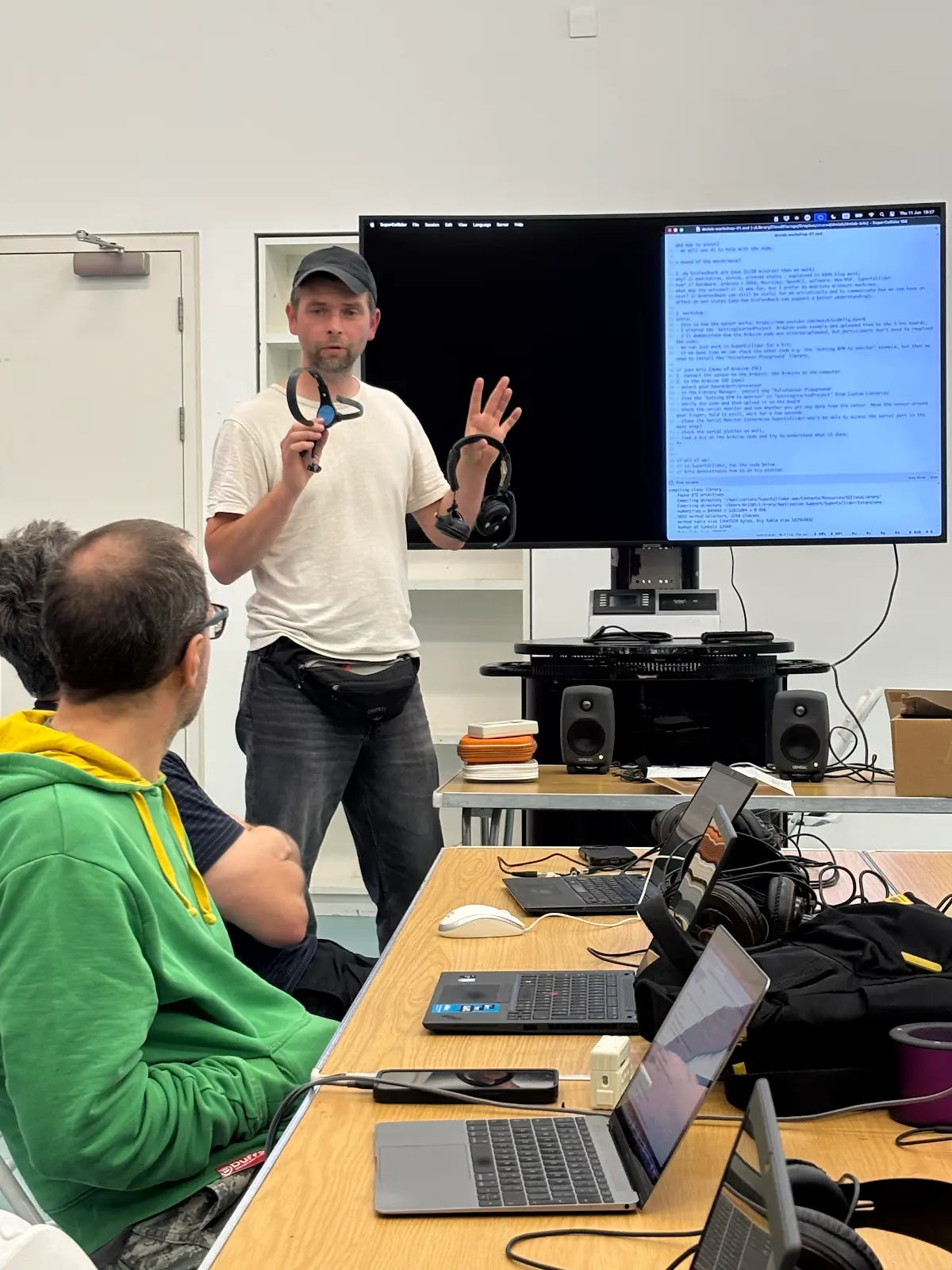 Kris presenting in from of people.