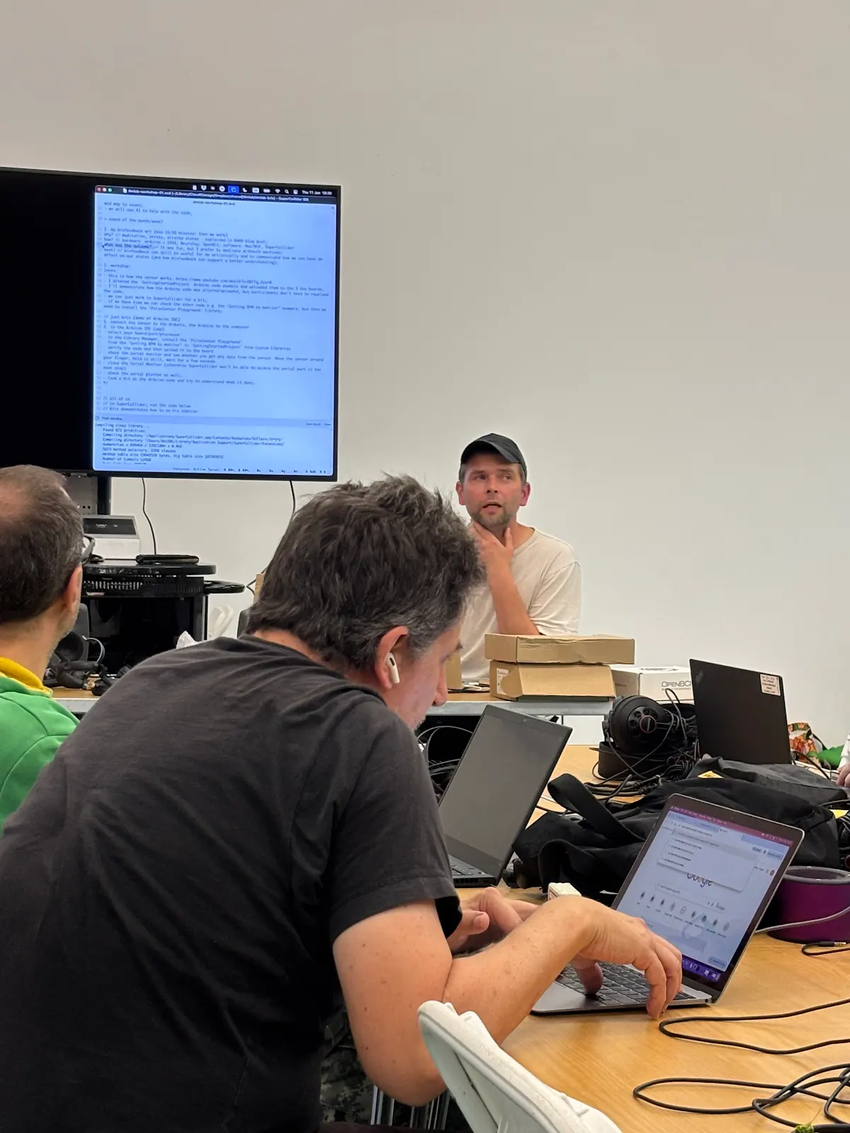 Kris presenting in from of people.